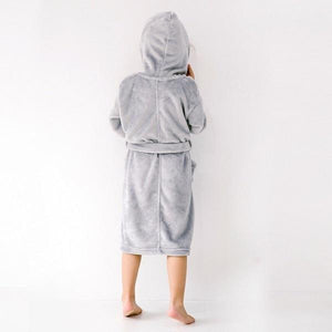 Girl wearing soft grey hooded robe - back view