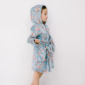 Girl wearing soft blue floral robe - side view